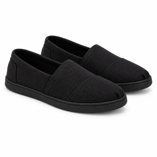 Pair of all-black canvas slip-on shoes at 45 degree angle
